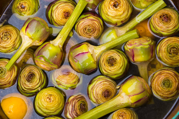 artichokes in water at farmer's market, rome
