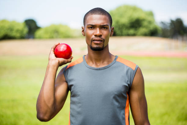 istock Male athlete holding shot put ball 660857076
