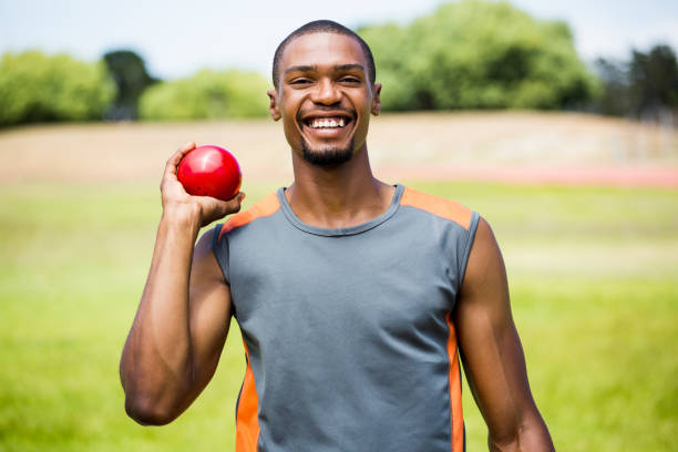 istock Male athlete holding shot put ball 660857218
