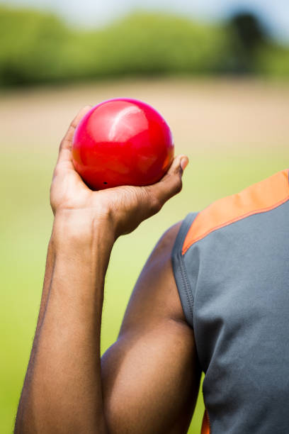 istock Male athlete holding shot put ball 660857456
