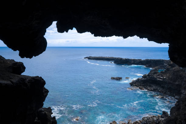 Looking out from inside Ana Kai Tangata or Cave of the Men Eaters on Easter Island, Chile.
