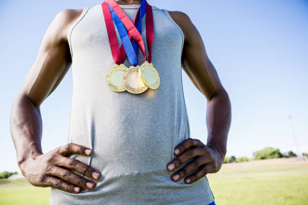 istock Athlete posing with gold medals around his neck 660862324