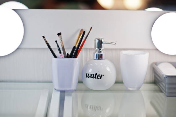 istock Make up brushes with bottle of water at beauty salon. 660864020