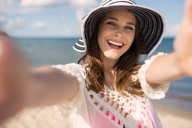 istock Young pretty woman in hat reaching out her hands 660870236
