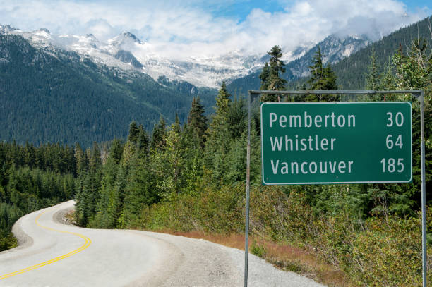 Road Sign in British Columbia A sign provides distances to popular destinations along a scenic road in British Columbia. pemberton bc stock pictures, royalty-free photos & images