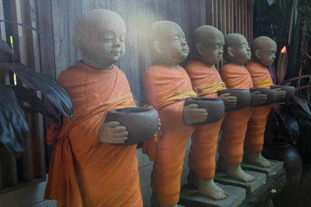 The statue of the monk looks calm.