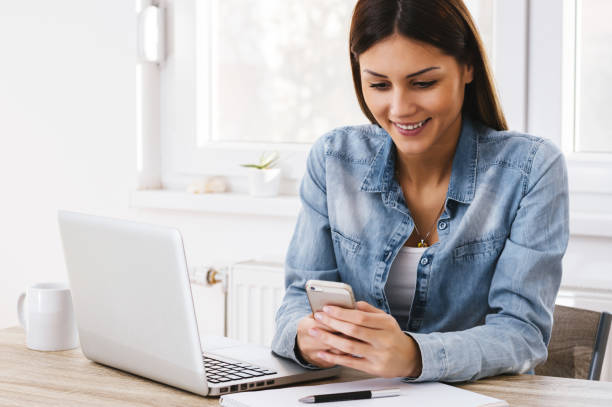 istock Woman working in home office with phone and computer 660896224
