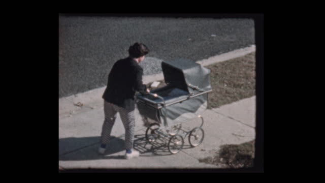Young girl pushes baby in antique stroller