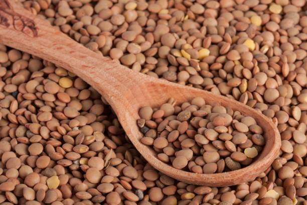 istock Lentils in a wooden spoon as background 660919768