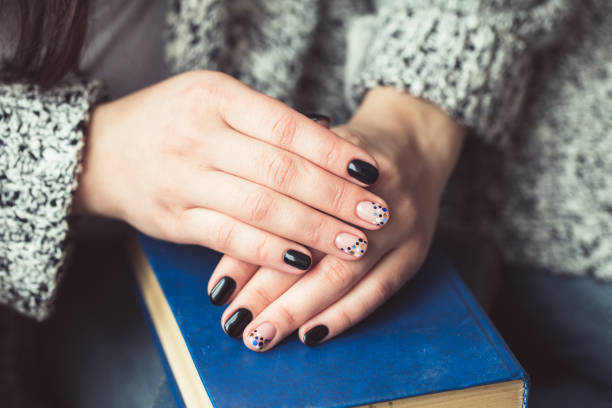istock Young woman reading book, close-up, on home interior 660921940