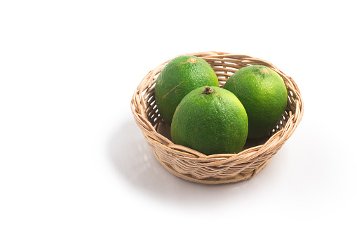 Tahiti Lemon into a basket isolated on white background