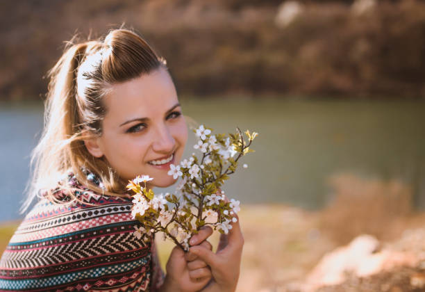 istock Women with a spring flower at mountain lake 660937694