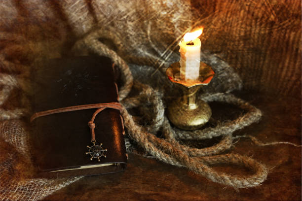 istock retro scratched effect on photo book candle feather and rope 660940282
