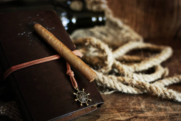 istock Cigar and leather notebook on a wooden background 660945094