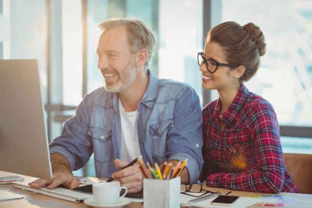 istock Male graphic designer working with coworker in office 660954874