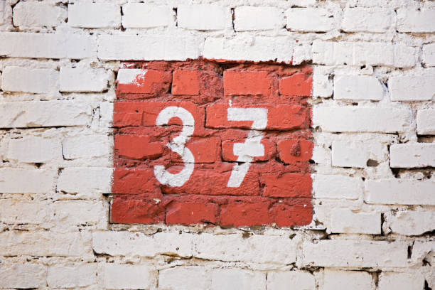 Number thirty-seven. On the background of the brick wall.
