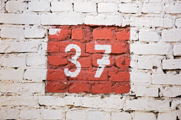 Number thirty-seven. On the background of the brick wall. numerals, number 37 number 37 stock pictures, royalty-free photos & images