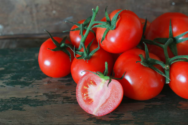 istock branch of tomatoes on wooden background 660962004