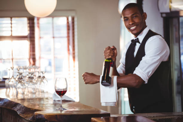 istock Portrait of bartender holding a wine bottle 660964044