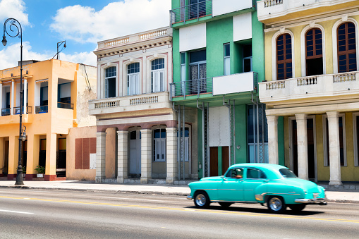 Classic American car drives on Malecon, Havana, Cuba