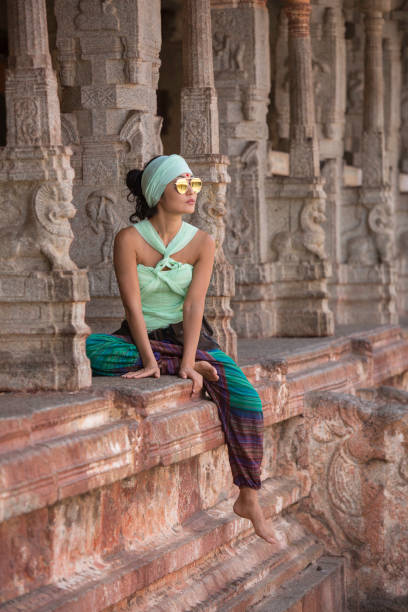 istock Beautiful girl sitting between the columns 661006010