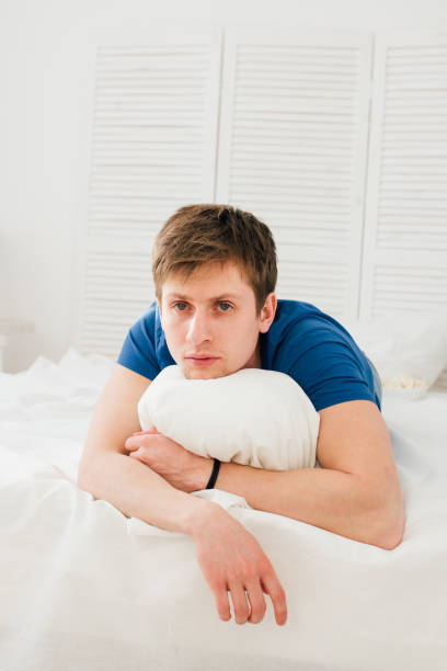 istock Man watching TV lying on the bed 661006522