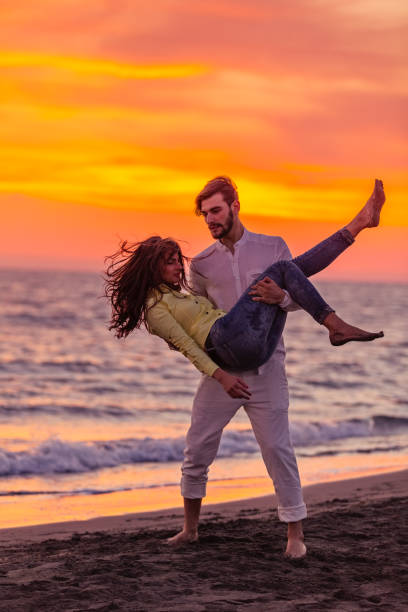 istock Young couple having fun on a sandy coast 661008324