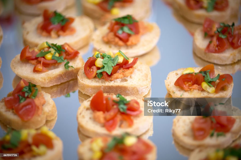 A plate full of little snack A plate full of littel snack with bread, tomatos and corn Appetizer Stock Photo
