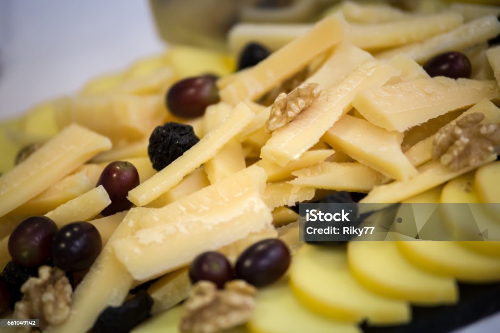 Dish with parmesan and fruit A dish full of chees, grapes and  nuts Appetizer Stock Photo
