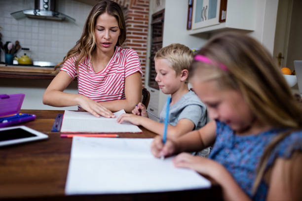 istock Mother helping kids with their homework 661053206