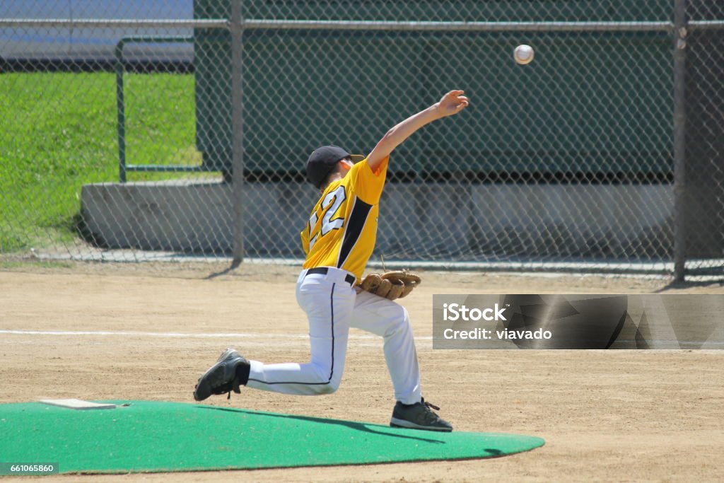 Pitching a Strike in Youth Baseball A young boy pitching a strike in a baseball game. Youth Baseball Stock Photo