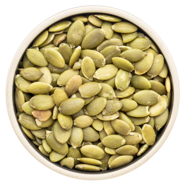 istock pumpkin seeds in a round bowl 661074668