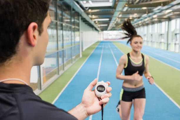 istock Trainer timing woman on the track 661079382