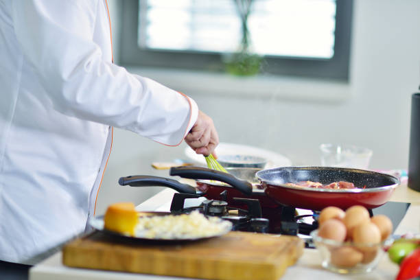 istock mature chef preparing a meal with various vegetables and meat 661081686
