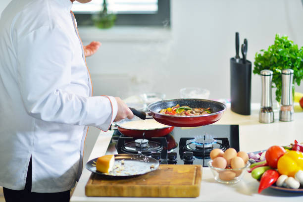 istock mature chef preparing a meal with various vegetables and meat 661082364