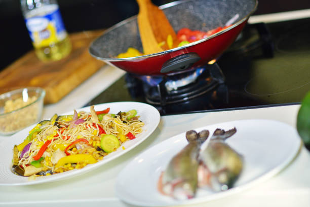 Vegetable ragout in pan, on wooden table on bright background.