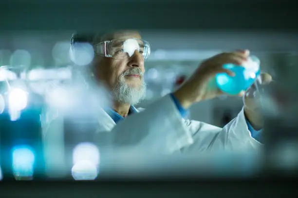 Photo of Senior male researcher carrying out scientific research in a lab