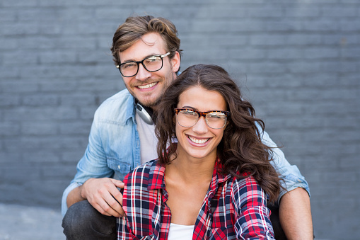 Portrait of happy young couple in spectacles