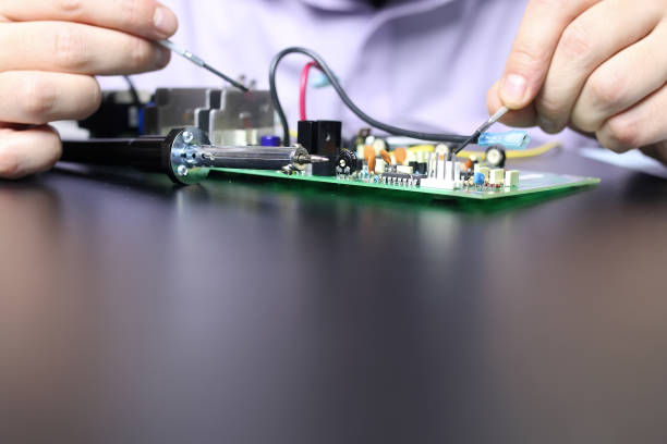 istock chip soldering man hands and foreground space for text 661098930