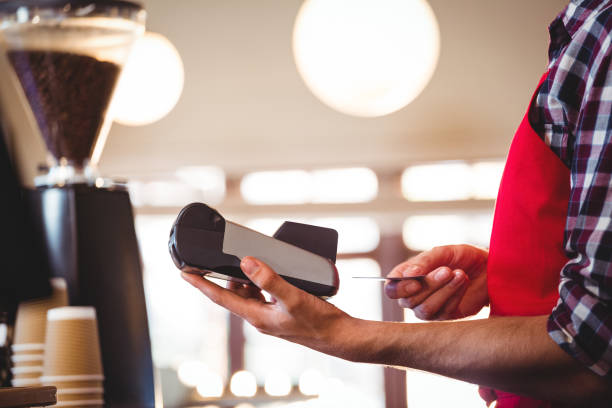 istock Waiter inserting customer's credit card into credit card machine 661146728