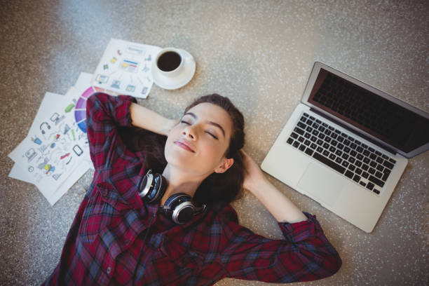 istock Female graphic designer lying on floor 661165988