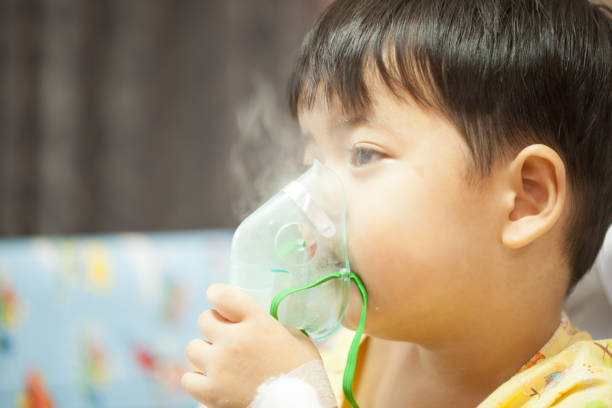 istock little boy wearing oxygen mask in hospital ward 661167510