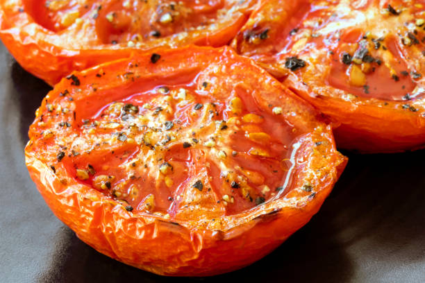 Roasted Tomatoes on Black Plate Side View Closeup
