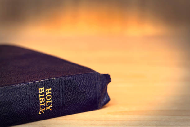istock Old Bible over Grunge Timber Background 661219338