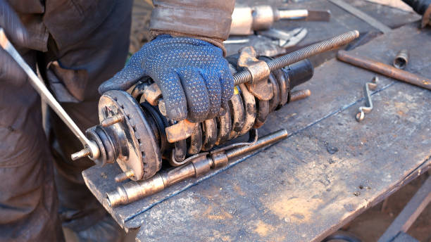 istock Auto mechanic working on shock absorber in garage 661220114