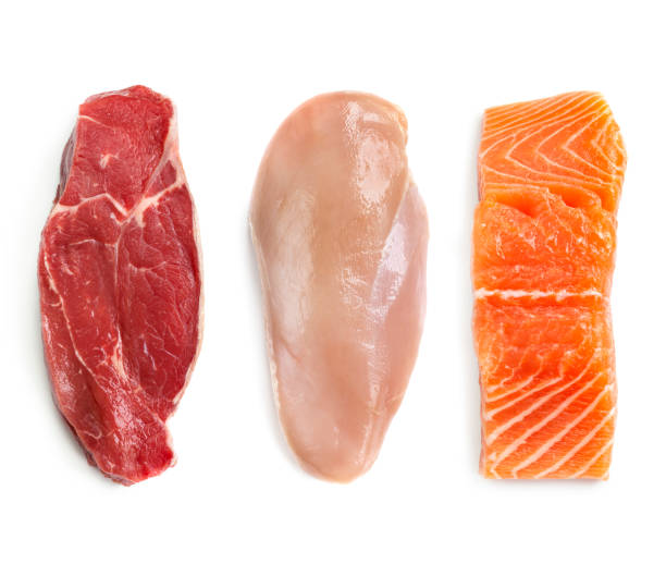 Raw Beef Chicken and Fish Isolated Top View Raw beef steak, chicken breast, and salmon, isolated on white.  Top view.  Lean proteins. salmon animal stock pictures, royalty-free photos & images