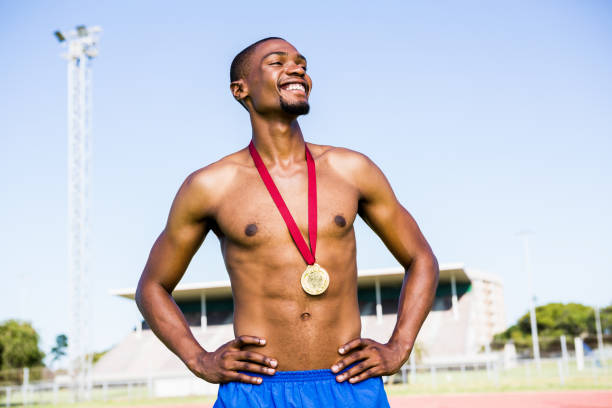 istock Athlete posing with gold medals around his neck 661247436