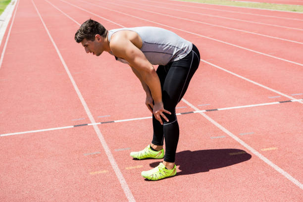 istock Tired athlete standing on running track 661254568