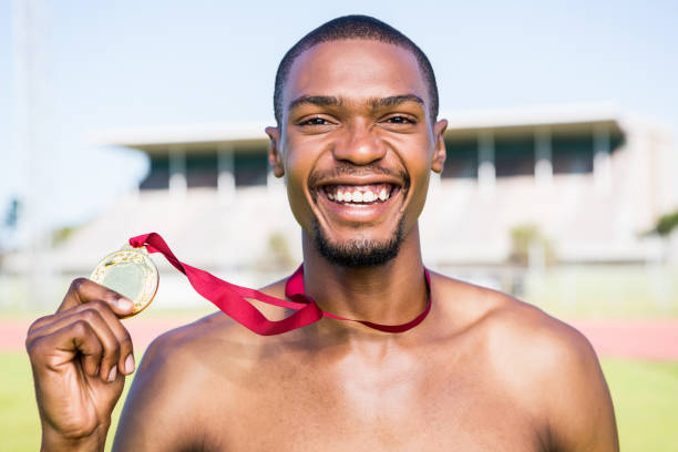 istock Athlete holding gold medal after victory 661254752
