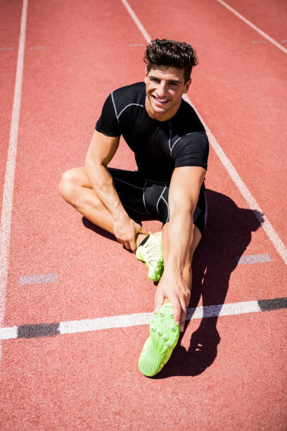 istock Tired athlete sitting on the running track 661256372